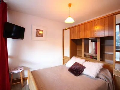 Un ou plusieurs lits dans un hébergement de l'établissement Appartement T3 avec Terrasse et Wifi au Mont-Dore - FR-1-608-178