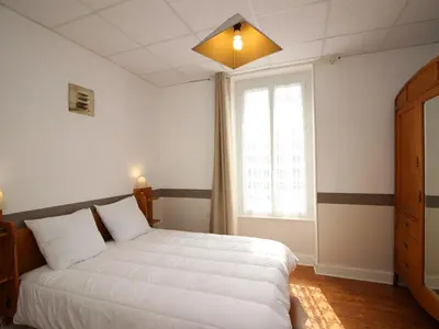 Un ou plusieurs lits dans un hébergement de l'établissement Appartement lumineux à La Bourboule, 3 chambres, proche centre - FR-1-608-39