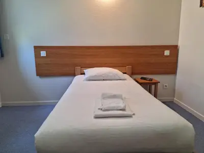 Un ou plusieurs lits dans un hébergement de l'établissement Hôtel Eden Lake