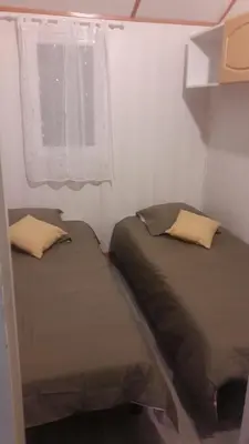 Un ou plusieurs lits dans un hébergement de l'établissement Chalet les Hameaux du Perrier