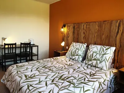 Un ou plusieurs lits dans un hébergement de l'établissement Auberge du Bois de l'étang - Motel les Tilleuls