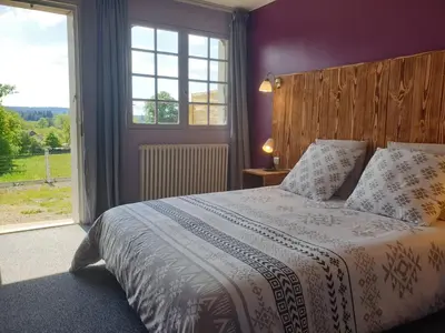 Un ou plusieurs lits dans un hébergement de l'établissement Auberge du Bois de l'étang - Motel les Tilleuls