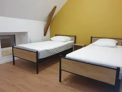Un ou plusieurs lits dans un hébergement de l'établissement Gîte Lepetit Sabotier grande capacité Puy de Dôme