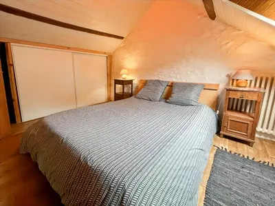 Un ou plusieurs lits dans un hébergement de l'établissement Maison chaleureuse au coeur de la nature Montignac Lascaux Dordogne 4 pers