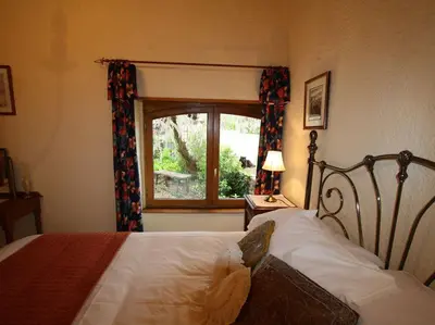 Un ou plusieurs lits dans un hébergement de l'établissement La Vieille Ferme: superbe complexe de 3 gîtes en pierre avec Piscine au coeur du Périgord Noir