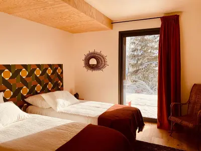 Un ou plusieurs lits dans un hébergement de l'établissement L'Avancée Chalet contemporain au coeur du Sancy AUVERGNE