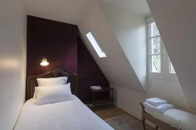 Un ou plusieurs lits dans un hébergement de l'établissement Hôtel de Colbert