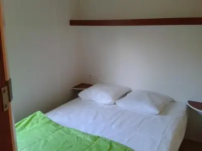 Un ou plusieurs lits dans un hébergement de l'établissement Camping maeva Escapades Au P'tit Bonheur