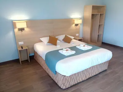 Un ou plusieurs lits dans un hébergement de l'établissement Brit Hotel Confort - La Tour Blanche