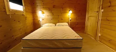 Un ou plusieurs lits dans un hébergement de l'établissement Les Chalets de La Vialette