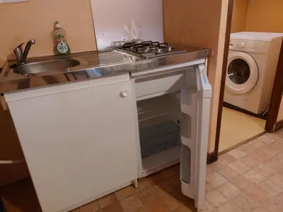 Cuisine ou kitchenette dans l'établissement Chambre Familiale