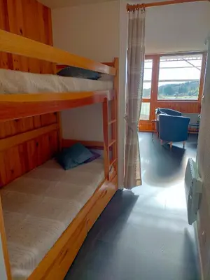 Un ou plusieurs lits dans un hébergement de l'établissement Appartement situé en plein centre à deux pas des pistes.