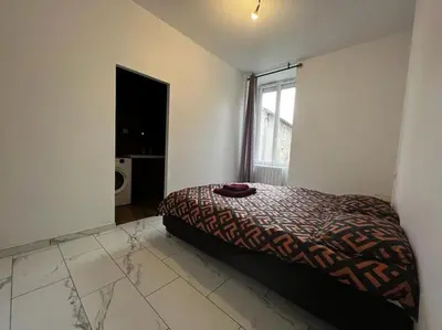Un ou plusieurs lits dans un hébergement de l'établissement Bel appartement en centre ville de Limoges