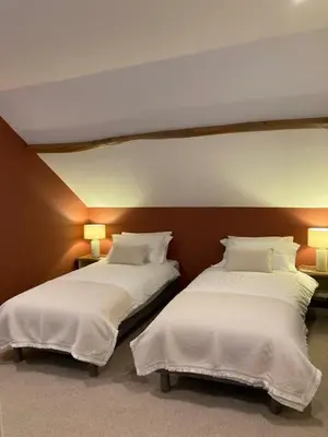 Un ou plusieurs lits dans un hébergement de l'établissement Chambres d'hôtes de La Vieille Ferme