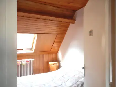 Un ou plusieurs lits dans un hébergement de l'établissement Appartement familial à La Bourboule - 55 m² avec TV dans la chambre