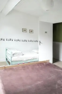 Un ou plusieurs lits dans un hébergement de l'établissement Appartement familial à La Bourboule - 55 m² avec TV dans la chambre