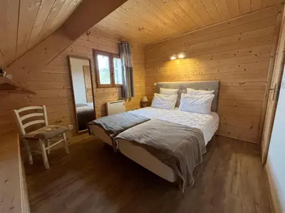 Un ou plusieurs lits dans un hébergement de l'établissement Chalet des Monts Dore