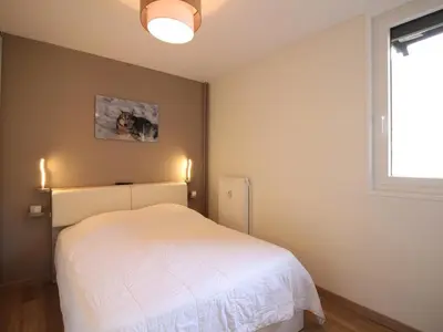 Un ou plusieurs lits dans un hébergement de l'établissement T2 Rénové avec Balcon et Parking au Mont-Dore - FR-1-608-244