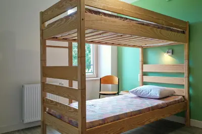Un ou plusieurs lits dans un hébergement de l'établissement Roue d'escampette Gîte d'étape et de séjour