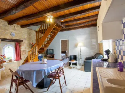 Coin salon dans l'établissement Charmante maison en pierre avec jardin clos, Tourtoirac - FR-1-616-280