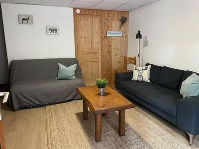 Coin salon dans l'établissement Appartement 4 personnes - CHALET COSY Mont Dore